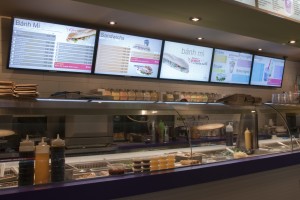 Digital menu board's central screen displays promotional messages