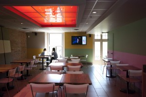 Digital TV with ads in upper dining area
